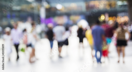 Abstract people are walking in the city. Blurred background.