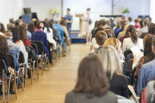 Two Hosts Speaking In front of the Large Group of People