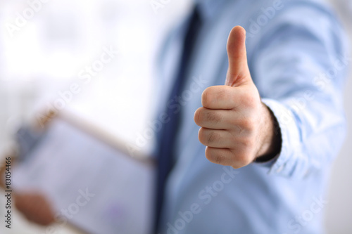 Business man showing ok, hand with thumb up photo
