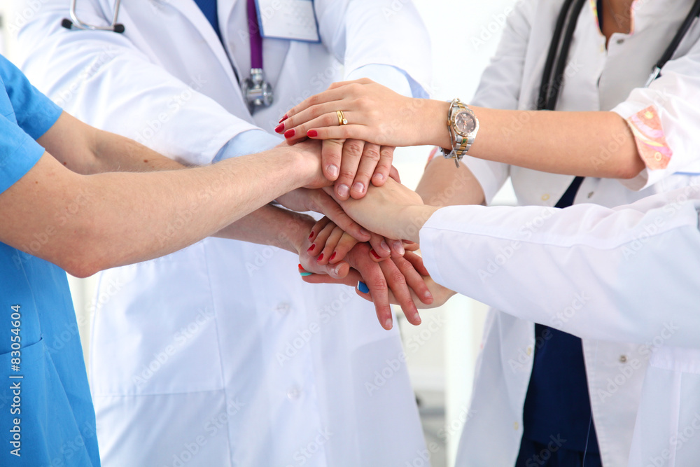 Doctors and nurses in a medical team stacking hands Doctors and nurses in a medical team stacking hands