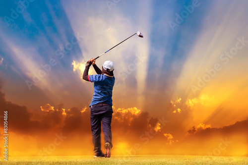 golfer hit golf ball on sunbeams background with fog 