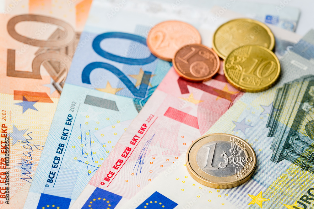 European money - one Euro coin with Euro cents and banknotes European money - one Euro coin with Euro cents and banknotes
