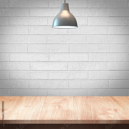 Wood table with Lamp and brick wall background