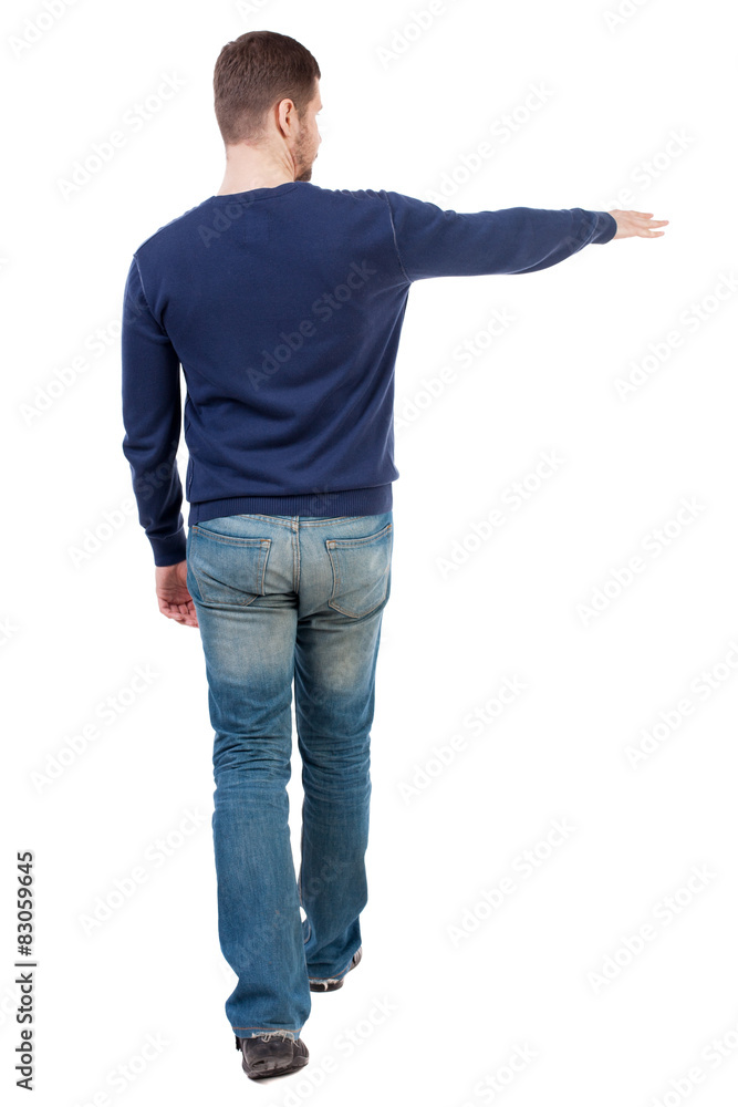 Back view of going handsome man in jeans pointing Back view of going handsome man in jeans pointing