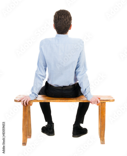 Wall Mural back view of business man sitting on chair.