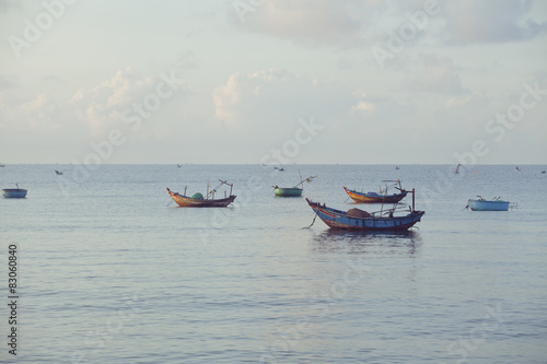 vietnameese national boats in sea at sunrise photo