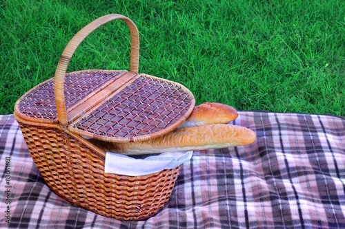 Picnic Basket With Two French Baguette On The Blanket