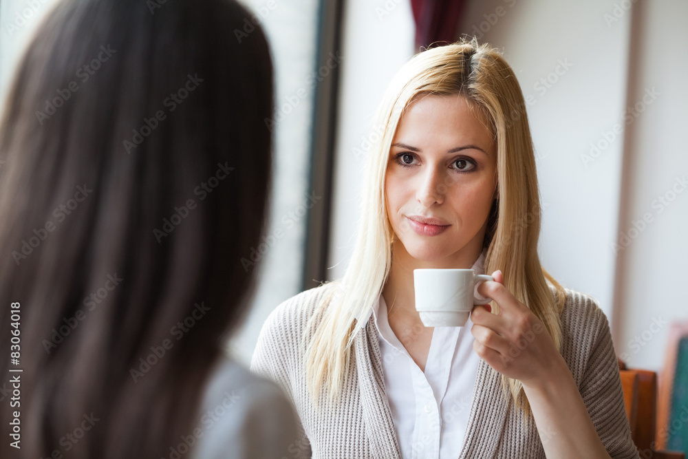 Two young women talking in cafe Two young women talking in cafe