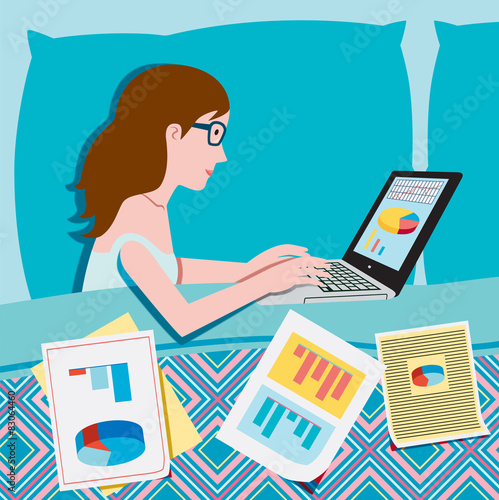 Woman in bed working on the laptop