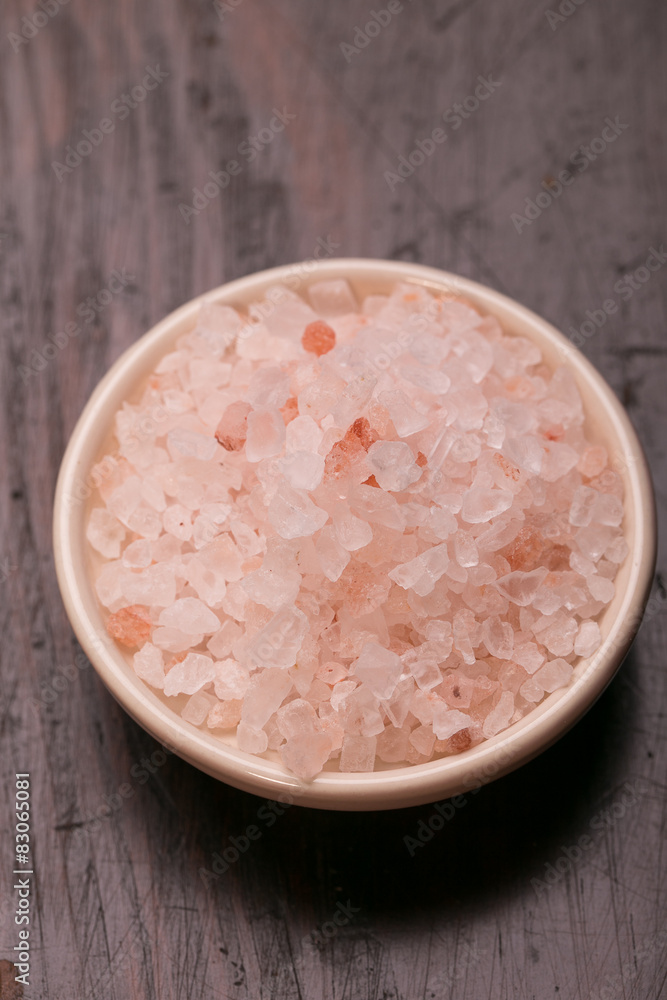 spoon of pink himalayan salt on wooden table spoon of pink himalayan salt on wooden table