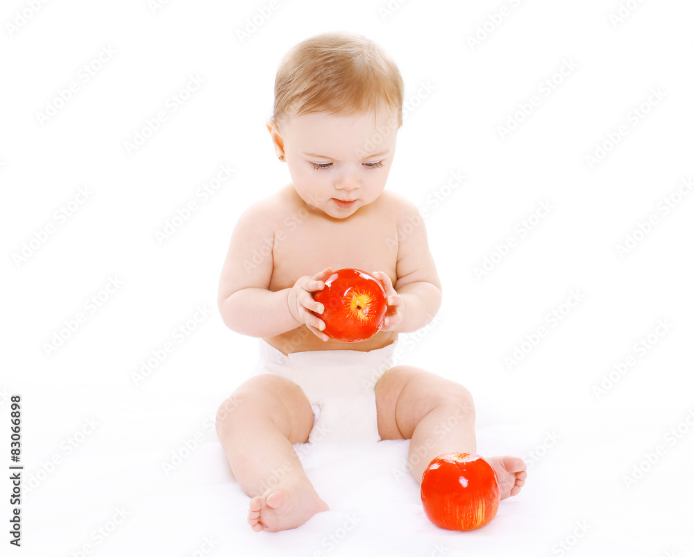Little baby sitting with reds apples on a white background Little baby sitting with reds apples on a white background