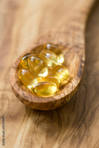 Fish oil capsules in a spoon