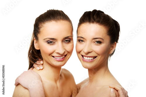 Two sisters with make up embracing.