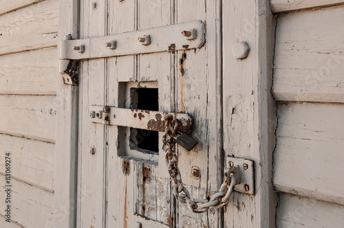 Old locked door with chain and padlocks