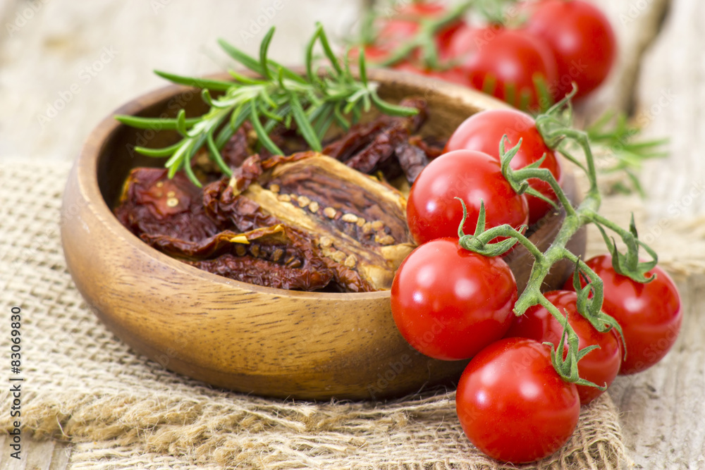 fresh and dried tomatoes on wooden background fresh and dried tomatoes on wooden background