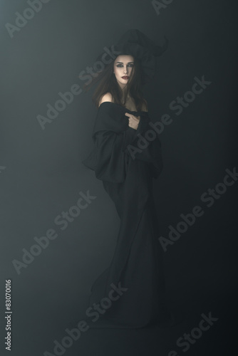 slender witch in a dark fog