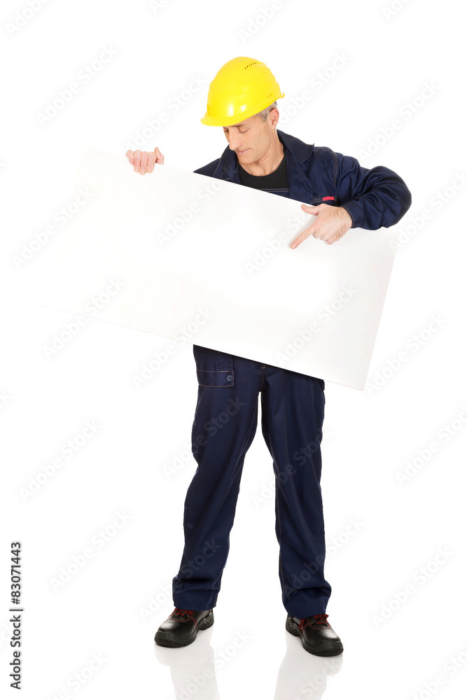 Happy worker presenting empty banner Happy worker presenting empty banner