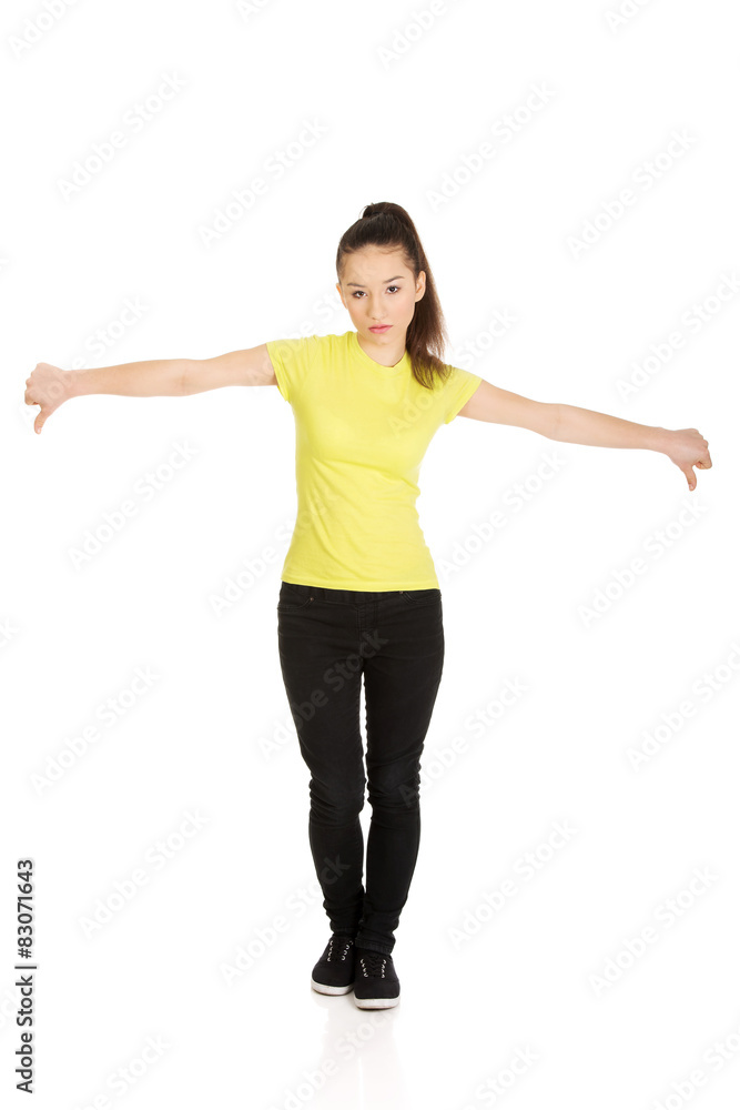 Unhappy woman with thumbs down. Unhappy woman with thumbs down.