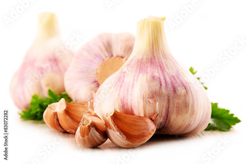Composition with bulbs of garlic isolated on white