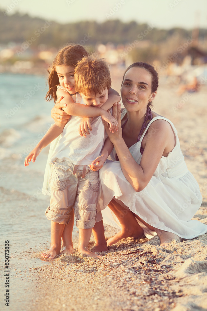 Portrait of young mother with two cute little children Portrait of young mother with two cute little children