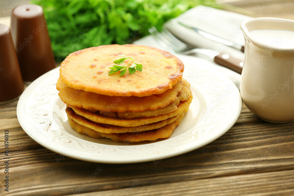 Stack of corn tortillas with stuffing and greens on wooden table background Stack of corn tortillas with stuffing and greens on wooden table background