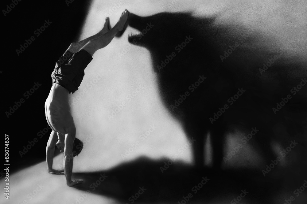 handstand with wolf silhouette