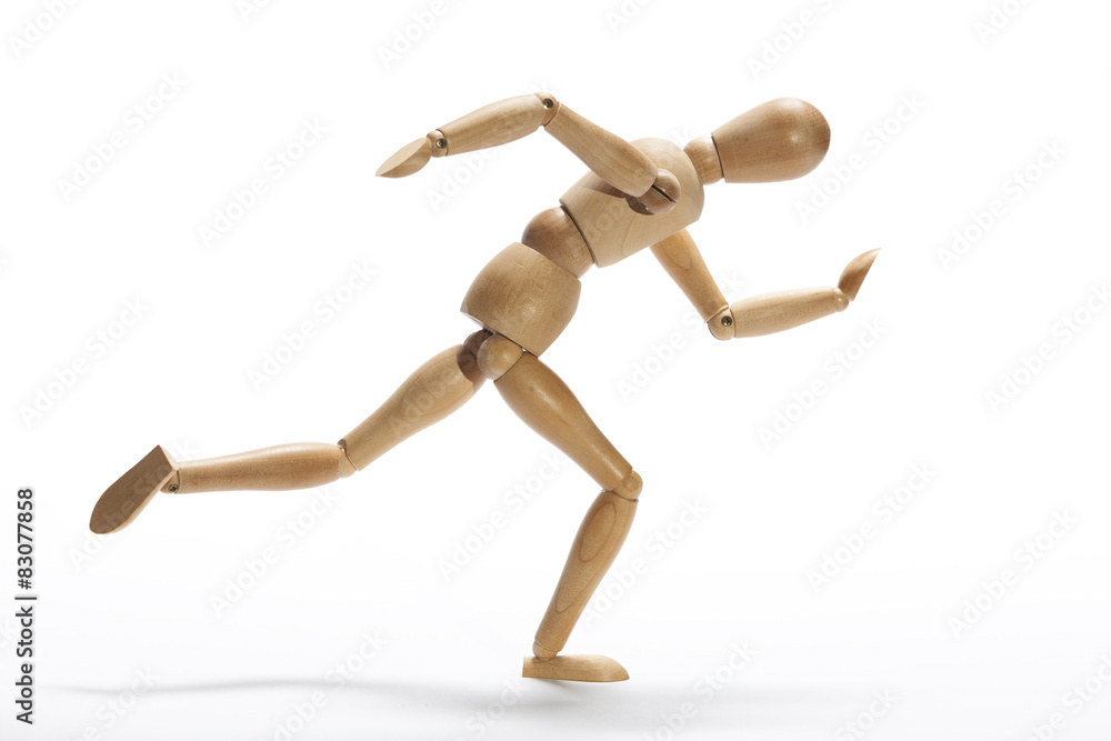 Wooden mannequin in intense sprint on a white background Wooden mannequin in intense sprint on a white background