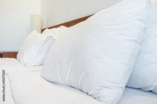 Bed, pillows, bedsheets and lamp in the hotel resort room