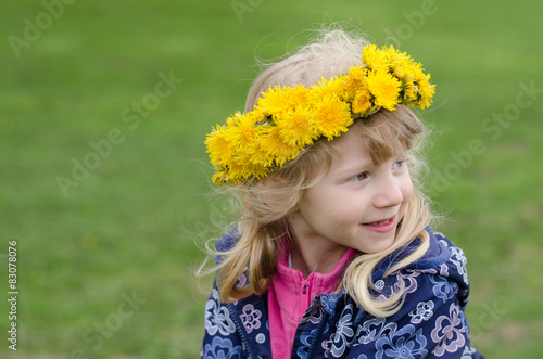 beautiful child with dandelion flowers over head