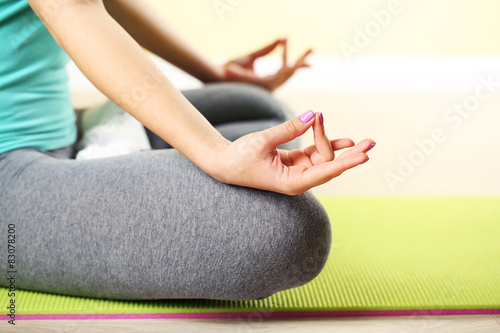 Hand yoga gesture on bright background