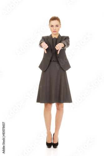 Business woman showing thumbs down.