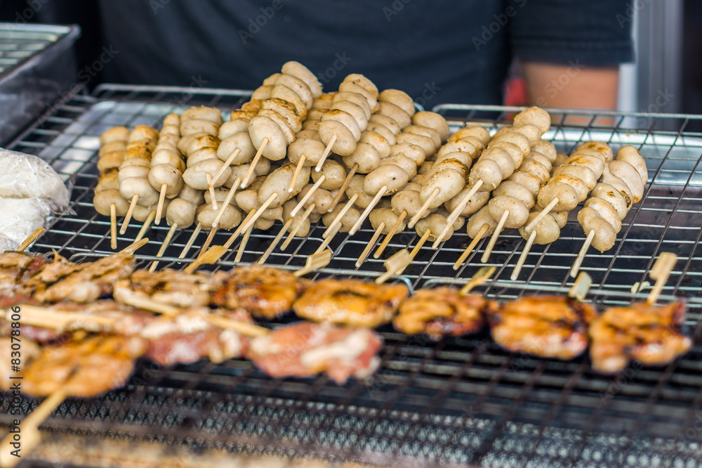Grilled pork ball skewers on iron grill for sale in Thailand mar