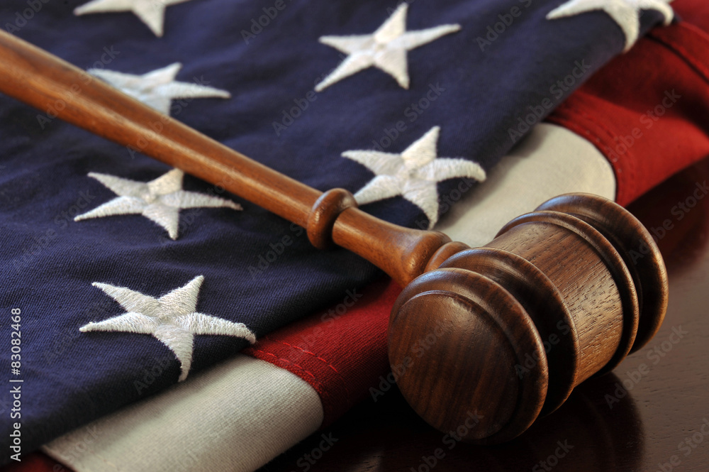 Wooden judge's gavel over an American flag