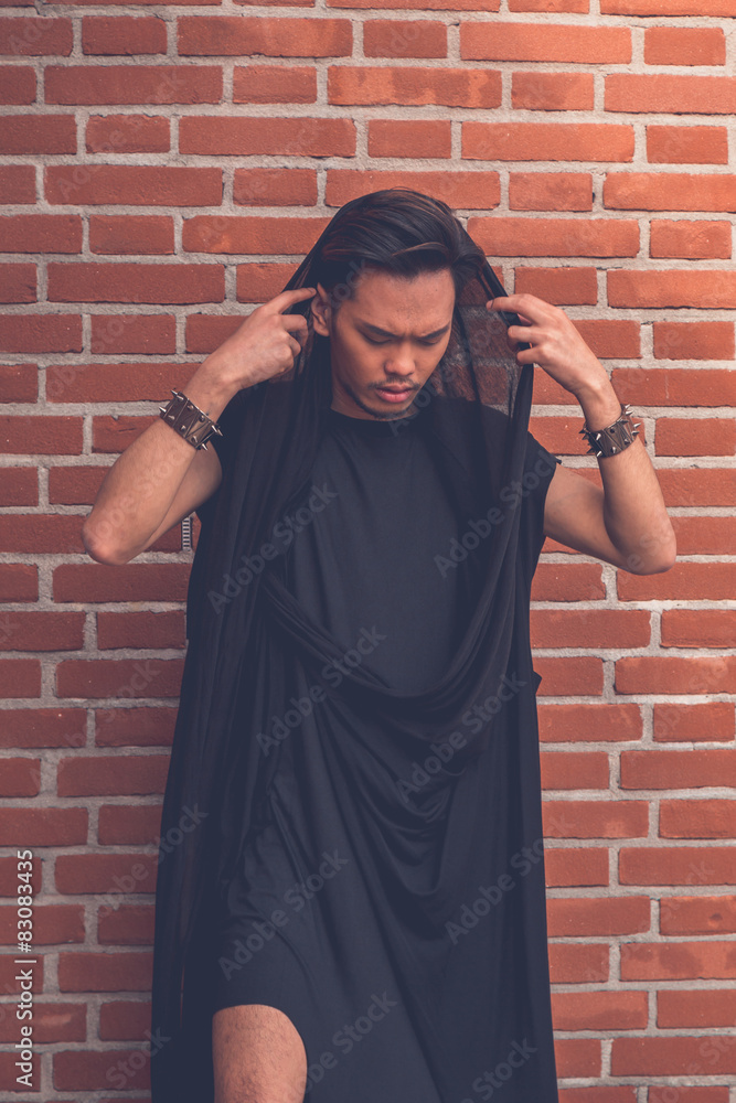 Naklejka premium Handsome Asian model posing in the city streets