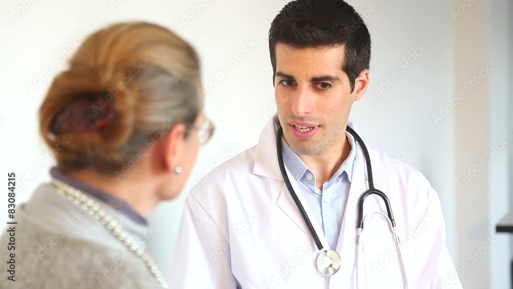 A doctor talks with a female patient A doctor talks with a female patient
