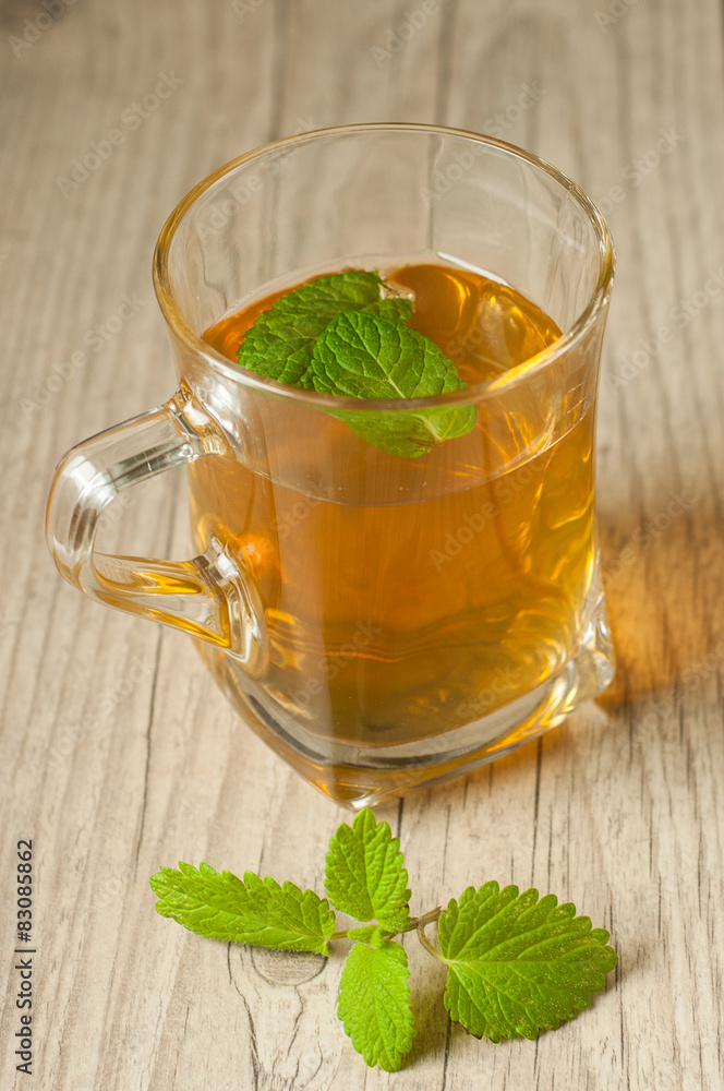 cup of tea with mint on wooden table cup of tea with mint on wooden table