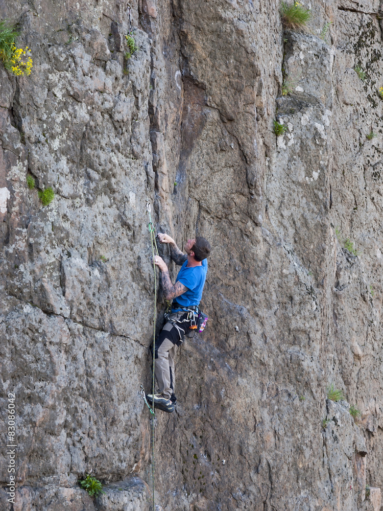 Beautiful man climbs a high mountain.