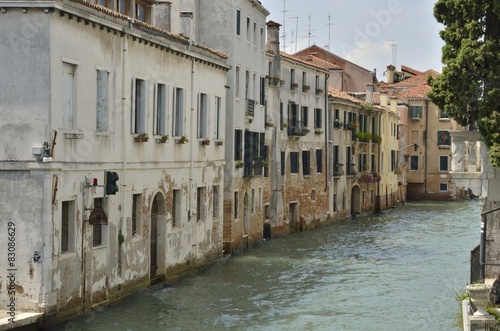 Old houses along a canal in Venice, Italy