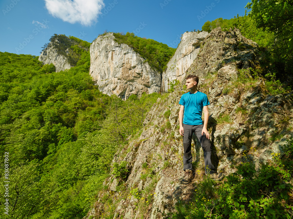Teenager boy posing on the mountains