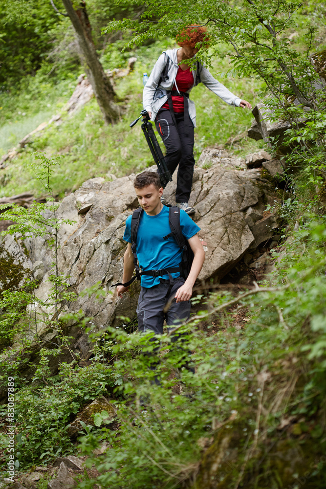 Family of hikers walking on a mountain trail