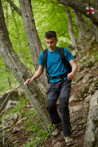Teenager hiker on a mountain trail