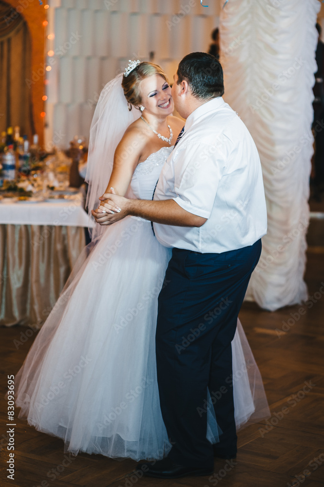 beautiful caucasian couple just married and dancing their first