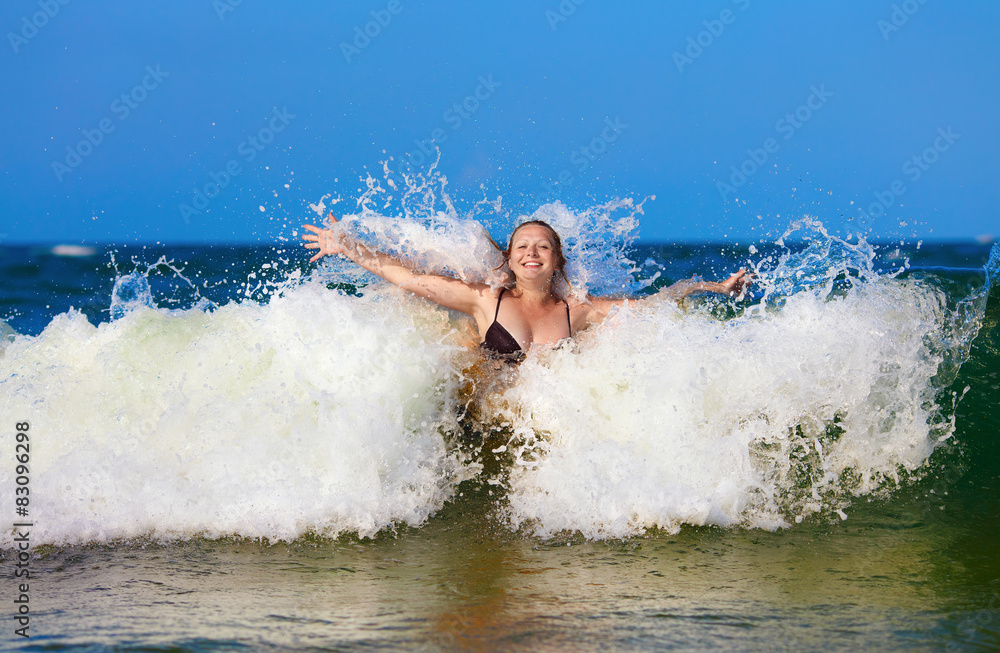 Woman in sea wave