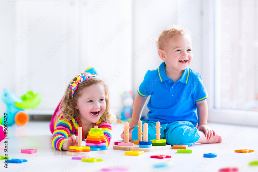 Fototapeta premium Cjildren playing with wooden toys