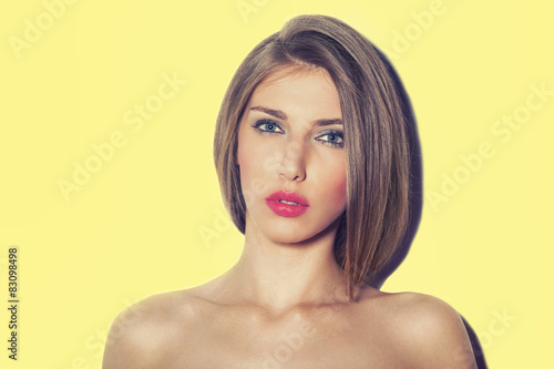 Portrait of a beautiful model on yellow background