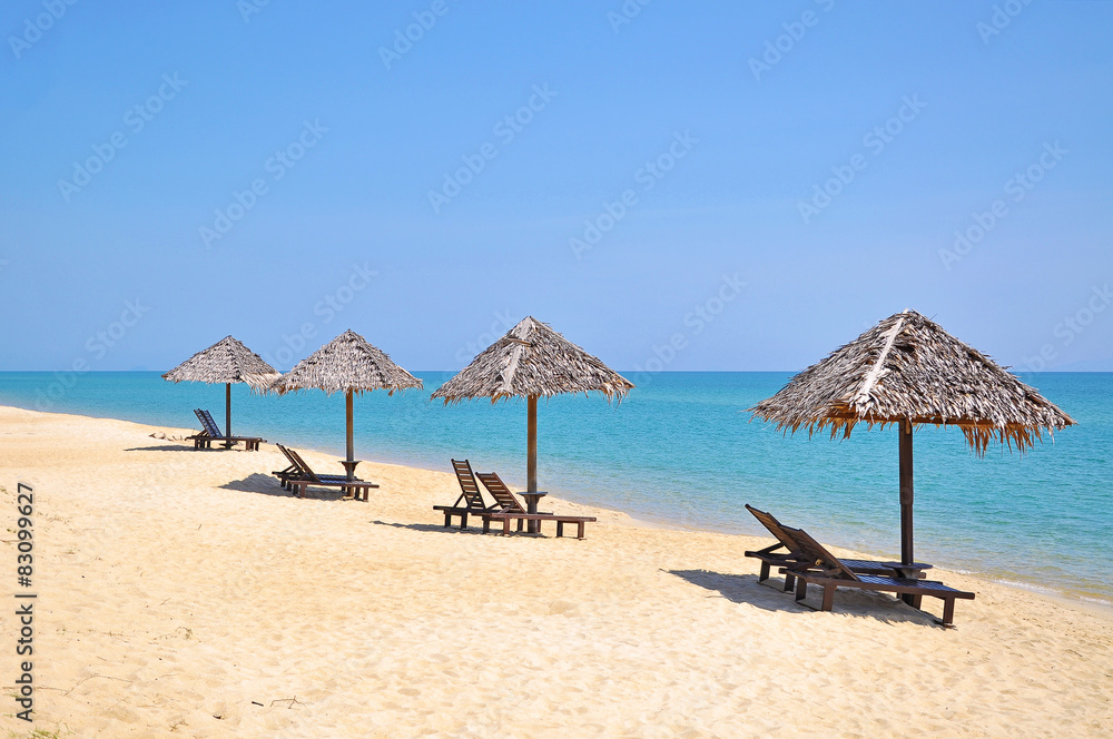 Beach chairs and umbrellas on a beautiful panoramic beach view a