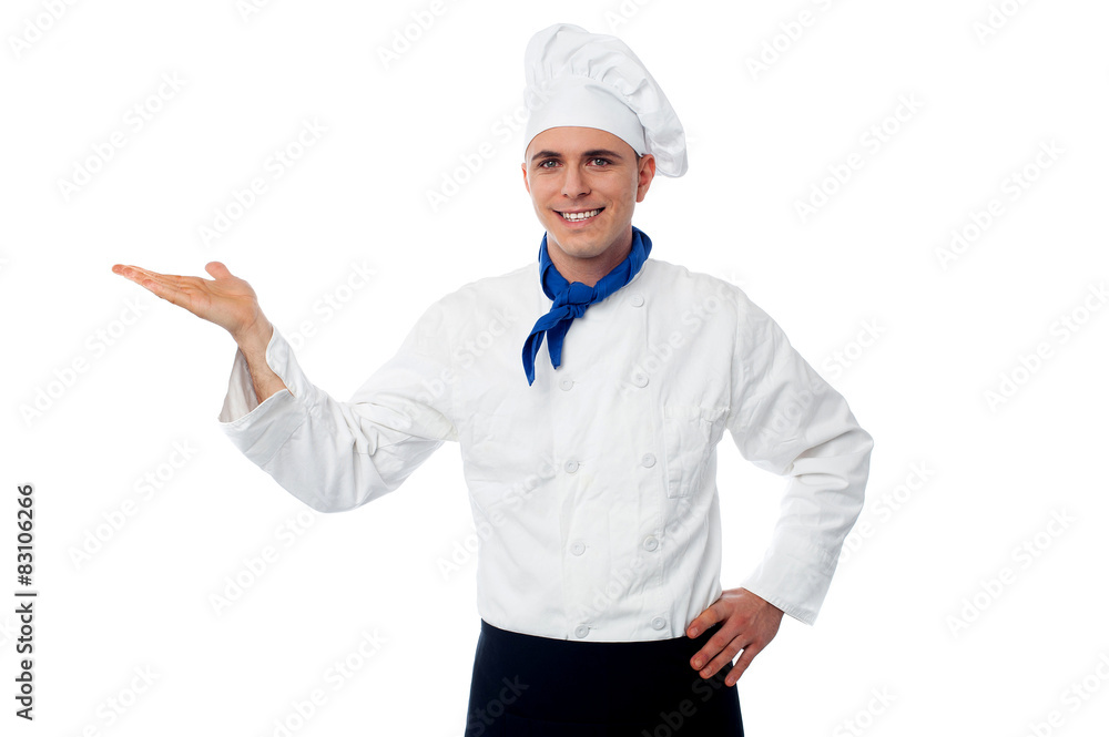 Smiling male chef showing something Smiling male chef showing something