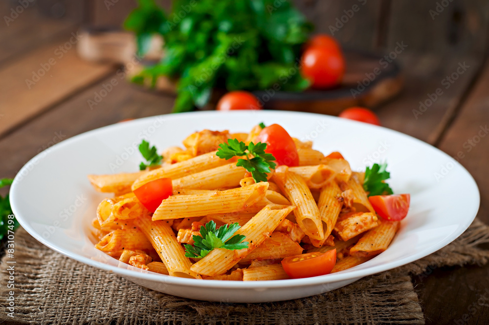 Penne pasta in tomato sauce with chicken, tomatoes Stock Photo | Adobe