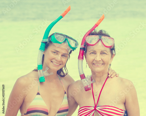 two woman with mask for snorkeling in the sea background