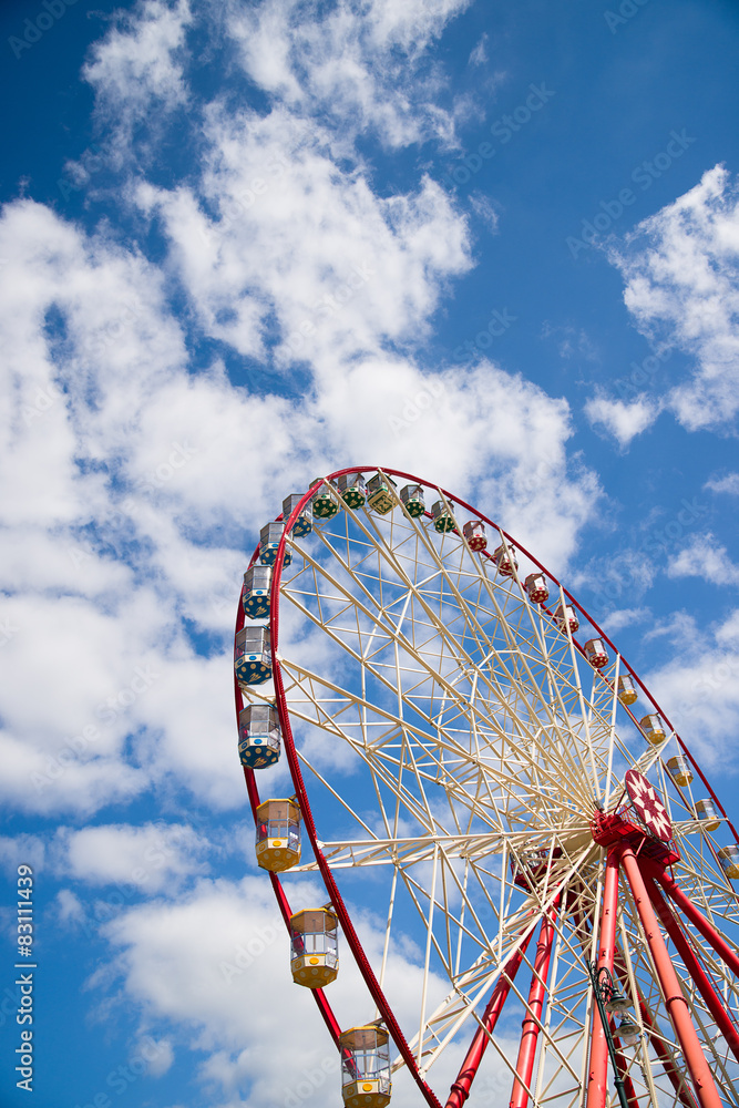 Atraktsion Ferris wheel against the blue sky Atraktsion Ferris wheel against the blue sky